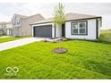 Well-maintained single-story home with green lawn, black garage door, and contrasting trim at 3261 W Keepsake Ln, Monrovia, IN 46157