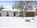Inviting single-story home with horizontal siding, trimmed windows, front door wreath, snow-covered yard, and address at 3415 N Wittfield St, Indianapolis, IN 46235