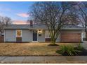 Inviting home exterior with horizontal siding, trimmed windows, front door wreath, manicured landscaping, and address at 3415 N Wittfield St, Indianapolis, IN 46235
