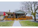 Charming home with a covered front porch, wooden railings, and decorative touches at 6047 Guilford Ave, Indianapolis, IN 46220