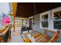 Charming porch with outdoor seating, including a swing, perfect for relaxation at 6047 Guilford Ave, Indianapolis, IN 46220