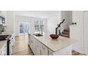 Modern kitchen with granite countertop, stainless steel dishwasher, and open concept living space at 6965 Equality Blvd, Carmel, IN 46033