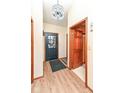 Welcoming foyer featuring a decorative light fixture, wood floors, and front door at 7344 Quartz Rock Rd, Indianapolis, IN 46236