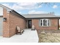 Charming front porch featuring two wooden Adirondack chairs and a decorative front door at 7344 Quartz Rock Rd, Indianapolis, IN 46236