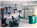 Spacious garage with tool rack and yard equipment, offering ample storage and organization for the homeowner at 7349 Doyal Dr, Whitestown, IN 46075