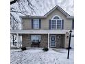 Inviting two-story home featuring a brick facade, covered porch, and traditional architectural details at 739 Quarterhorse Run, Bargersville, IN 46106