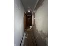 Interior hallway featuring wood-look doors and newly plastered walls at 7643 S Delaware St, Indianapolis, IN 46227