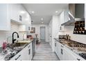 Modern kitchen with white cabinets, granite countertops, and stainless steel appliances at 8545 Olde Ml Trce, Indianapolis, IN 46260