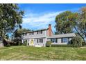 Charming two-story home with light gray siding, black shutters, and a bright yellow front door at 908 Whispering Trl, Greenfield, IN 46140