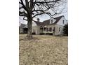 Attractive stone home showcases a classic design and established trees at 950 Ellenberger Pkwy West Dr, Indianapolis, IN 46219