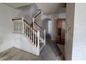 Open-concept entryway features a carpeted floor and a staircase at 1017 Grovewood Dr, Beech Grove, IN 46107