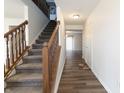 Inviting foyer with hardwood floors and a staircase leading to the upper level at 11005 Long Lake Ln, Fishers, IN 46037