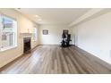 Bright living room featuring a cozy fireplace, hardwood floors, and ample natural light at 11005 Long Lake Ln, Fishers, IN 46037