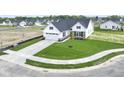 Aerial view of a home featuring a white facade, a two-car garage, a manicured lawn and landscaping at 1202 Brightwood Cir, Greenfield, IN 46140