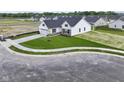 A high angle view of a home featuring manicured front lawn, a two-car garage and landscaping at 1202 Brightwood Cir, Greenfield, IN 46140