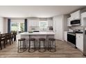 A modern kitchen with a large island, stainless steel appliances, and hardwood floors at 1202 Brightwood Cir, Greenfield, IN 46140