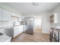 Bright kitchen features white cabinetry, stainless steel appliances, and hardwood floors at 1718 Charles St, Anderson, IN 46013