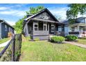 Eye-level view of the home featuring landscaping and a stone exterior at 1933 Koehne St, Indianapolis, IN 46202