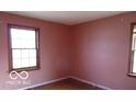 Neutral bedroom featuring two windows and wood floors at 305 Mohawk St, Anderson, IN 46012