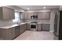 Modern kitchen features stainless steel appliances, gray cabinets, and marble countertops at 3121 W 13Th St, Anderson, IN 46011