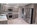 Bright kitchen featuring stainless steel appliances, grey cabinets, and ample counter space at 3121 W 13Th St, Anderson, IN 46011