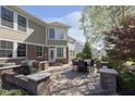 Beautiful backyard brick patio with an outdoor dining set and built-in seating area at 3236 Willow Bend Trl, Zionsville, IN 46077