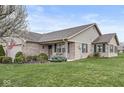 Attractive single-story brick home features a well-maintained lawn, manicured shrubs, and inviting curb appeal at 4038 Oak Trail Dr, Indianapolis, IN 46237