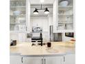 A bright, all-white kitchen with stainless steel appliances, modern fixtures, and ample counter space at 430 N Park Ave # 309, Indianapolis, IN 46202
