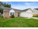 This single-Gathering home is nicely landscaped with a two-car garage and great curb appeal at 4619 Churchill Downs Cir, Greenwood, IN 46143