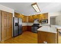 Functional kitchen with wood cabinetry, stainless steel refrigerator, and ample counter space for meal preparation at 4859 W 150 N, Greenfield, IN 46140