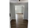 Hallway featuring modern laminate flooring and gray paint leading to additional rooms in the home at 5139 S Keystone Ave, Indianapolis, IN 46227