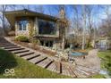 Beautifully landscaped exterior featuring a charming stone and brick design with a pathway and water feature at 5400 W Deer Run Ct, Muncie, IN 47304