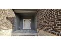Inviting entryway featuring a white door with sidelights and stylish brick and siding accents at 6641 Stone Pointe Way, Indianapolis, IN 46237