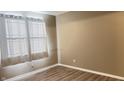 Well-lit bedroom featuring light-colored walls, plank flooring, and window that brings in natural light at 673 Ballycastle Ct, Pendleton, IN 46064