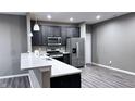 Modern kitchen with stainless steel appliances, a breakfast bar, and pendant lighting fixtures at 673 Ballycastle Ct, Pendleton, IN 46064