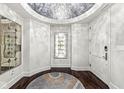 Elegant foyer with a decorative mirror, stylish chandelier, and white walls, creating a welcoming entrance at 720 S Rangeline Rd # 601, Carmel, IN 46032