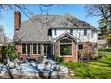 Patio with outdoor seating, lush landscaping, and expansive windows, offering a serene outdoor living space at 8845 Otter Cove Cir, Indianapolis, IN 46236