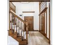 Elegant foyer featuring hardwood floors, a staircase, and ample natural light, creating a grand entrance at 8845 Otter Cove Cir, Indianapolis, IN 46236
