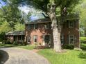 Beautiful two-story brick home with a well-maintained lawn and mature trees at 925 Forest Dr, Anderson, IN 46011