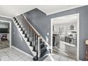 Open foyer with staircase; seamlessly transitions to a living area, enhancing the home's flow and spacious feel at 925 Forest Dr, Anderson, IN 46011