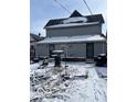 A view of the back exterior, showcasing the home's siding, and a snowy backyard at 926 River Ave, Indianapolis, IN 46221
