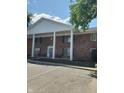 Brick building featuring a welcoming blue door and white support columns under a bright blue sky at 930 Park Central S Dr # 930C, Indianapolis, IN 46260