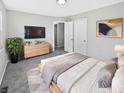 Bedroom featuring neutral paint, a television, and closet space at 102 Plummer Ave, Bargersville, IN 46106