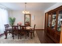 Formal dining room with hardwood floors, a large china cabinet, and a dining table set for six at 1136 Meriman Dr, Greenwood, IN 46143