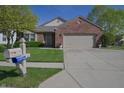 Attractive brick home with a well-manicured lawn, mailbox and an attached two-car garage at 1232 Severn Ct, Greenwood, IN 46142
