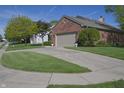 Charming brick home with an attached garage, a well-maintained lawn and flower pots at 1232 Severn Ct, Greenwood, IN 46142