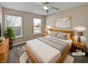 Comfortable bedroom with a large window, ceiling fan, and stylish decor at 14466 Bramkrist Dr, Fishers, IN 46038