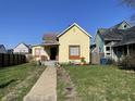 Charming yellow single Gathering home with a cozy porch and well-kept front yard, great curb appeal at 1640 Bellefontaine St, Indianapolis, IN 46202
