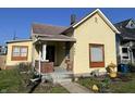 Charming yellow single Gathering home with a cozy porch and well-kept front yard, great curb appeal at 1640 Bellefontaine St, Indianapolis, IN 46202