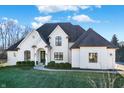 Beautiful white brick home featuring dark accents, manicured landscaping, and an inviting entrance at 2071 Eagle Trace Dr, Greenwood, IN 46143